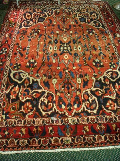 Hand Loomed Wool Iranian Rug: Hand Loomed Wool Iranian Rug: 4 Banded Border with Quarter Medallion Corners. Red Ground Field with Stylized Floral. 5' 10" X 9'. (300-600)