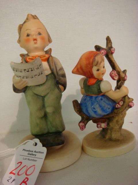 Two Hummel Boy and Girl Figurines: Apple Tree Girl and Soloist Hummel Figurines: 141 1/0, 3 1/2"T, TMK3. 4 1/2"T Boy #135 is 4 1/2"T, TMK2. (50-100)