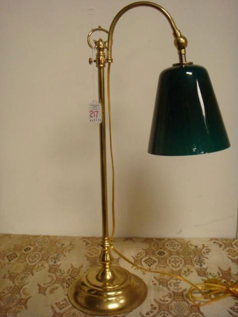Brass Lamp with Green Glass Shade: Brass Lamp with Green Glass Shade: Marked Steven Schrier LTD on Bottom. Lamp has Curved Brass Stem and Holds a Green Cased Glass Shade on Adjustable Holder. Dent in Foot. (60-120)