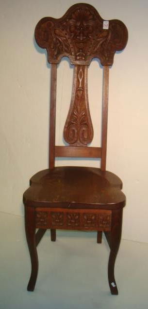 Carved Oak North Wind Side Chair: Carved Oak North Wind Side Chair: Chair has Carved Front Apron, Splat and Face with Leaves on Crest. 48 1/2"T at Back. Shaped Seat. (80-140)