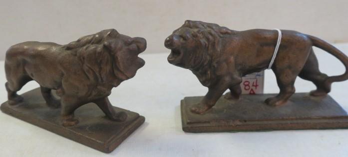 Pair of Solid Bronze Lion Mid-Century Bookends:: Pair of Solid Bronze Lion Mid-Century Bookends: Two Open Mouth Male Lions Cast in Heavy Bronze. Base Measures 6" X 2". Lion Figure is 7"Long, 3 1/4" Tall. (200-400)
