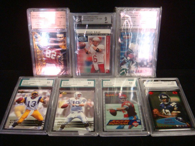 7 Graded Football Cards 10 to 8.5:: 7 Graded Football Cards 10 to 8.5: Michael Westbrook, Ryan Leaf, Daunte Culpepper, Kurt Warner, Peyton Manning Joe Montana, Keyshawn Johnson. Graded in Sealed Plastic Sleeves. (100-250)