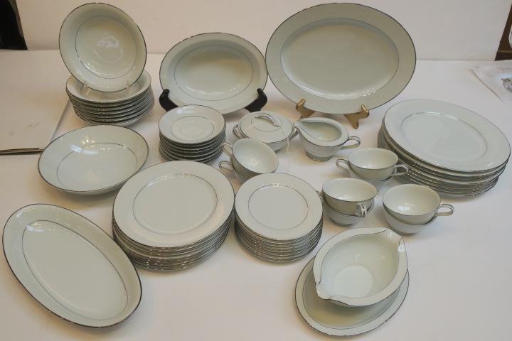 NORITAKE "Buckingham" Pattern Dinnerware, 54 Pcs:: NORITAKE "Buckingham" Pattern Dinnerware, 54 Pcs: White Flowers on White Ground, Platinum Rims. CA 1963-86. Includes 8 Each Dinner, Salad and Bread Plates, Soup Bowls, Cups and Saucers. Lidded Sugar a