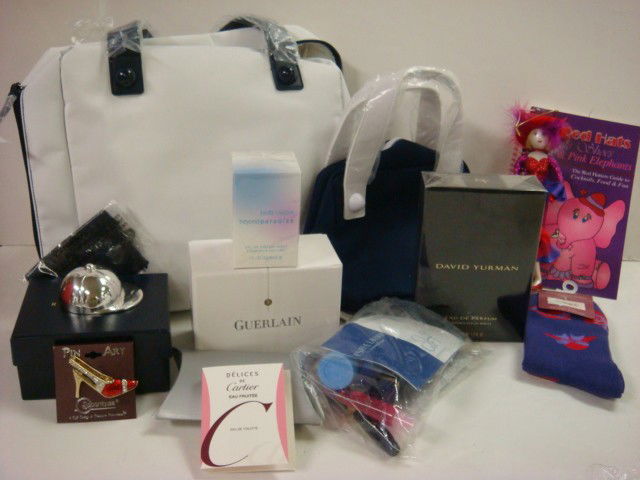 New Estee Lauder Tote Bag with Red Hat Sox, Recip: New Estee Lauder Tote Bag with Red Hat Sox, Recipee Book, Pin and Ornament. Also Estee Lauder Cologne, Makeup, Yurman Cologne, Ralph Lauren Jockey Cap Bottle Opener, Guerlain Makeup. (100-200)