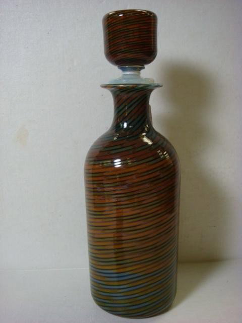 Murano Swirled Art Glass Bottle with Stopper:: Murano Swirled Art Glass Bottle with Stopper: In Colors of Browns, Tans, Greens and Blues Swirled Together with Opalescent Interior and Rim. Matching Stopper Top with Opalescent Stopper Bottom. 14"T. 