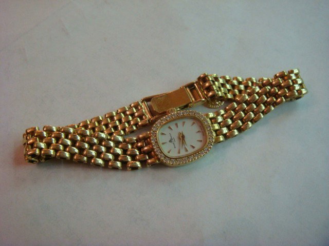 14 KT BAUME & MERCIER Gold & Diamond Watch: 14 KT BAUME & MERCIER Ladies Gold & Diamond Watch: 28 Diamonds Surrounnd the Face of this Elegant Ladies Watch. Gold Mesh Band, Added 14 KT Gold Disk Charmof St. Christopher.