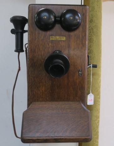 WESTERN ELECTRIC Oak Case Wall Phone:: WESTERN ELECTRIC Oak Case Wall Phone: Vintage Piece with Hand Crank that Turns Internal Generator to Ring the Operators Switchboard through the Bells. Plain Front with Tilting Mouthpiece Assembly, Pon