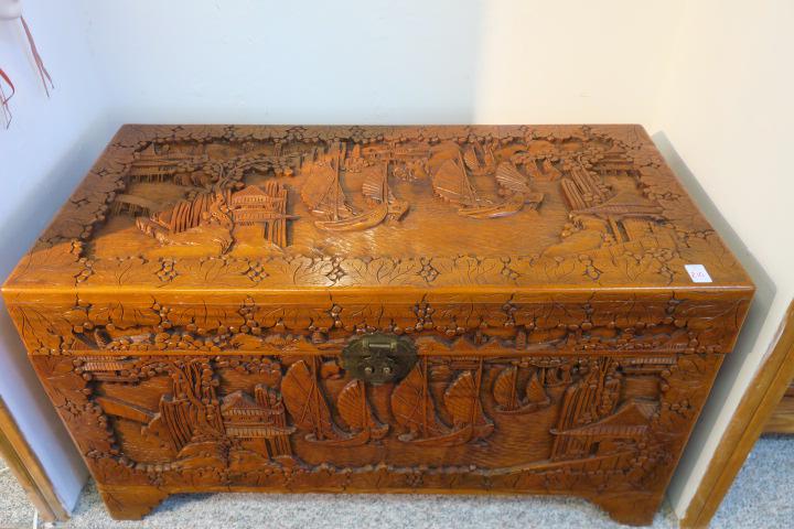 Hand Carved Asian Camphor Wood Chest, CA 1940's:: Hand Carved Asian Camphor Wood Chest, CA 1940's: Deeply Carved Harbor Scene with Boats, Surrounded by Village and Trees on Top and All Sides. Brass Hasp. 23 1/2"T, 41" X 20". ($200-$400)