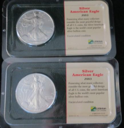 Two 2003 AMERICAN EAGLES 1 Troy Oz. 99.9% Pure Silver:: Two 2003 AMERICAN EAGLES 1 Troy Oz. 99.9% Pure Silver: Uncirculated Silver Coins from the Littleton Coin Company. In Sealed Plastic Covers. All in Excellent Condition. (140-200)