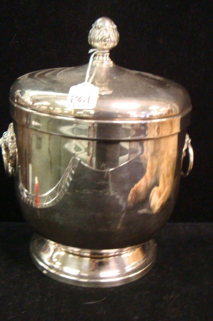 FB ROGERS Silver-plate Ice Bucket with Tongs: FB ROGERS Silver-plate Ice Bucket with Tongs: Ice Bucket has Porcelain Liner. Lions Heads with Rings on Sides. Hammered Handle Tongs. 11 1/2"T. (40-60)
