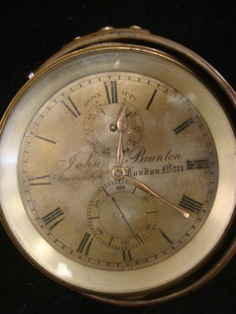 Brass Ships Clock in Gimble Mount, JOHN BRUTON:: Brass Ships Clock in Gimble Mount, JOHN BRUTON: 19th Century Ships Clock with Hours, Minutes and Second Hands. Labeled "JOHN BRUTON, AMERICAN SQN, LONDON No 511". Roman Numerals for Hours and Arabic f