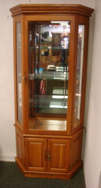 Golden Oak Lighted Curio with Lower Cabinet:: Golden Oak Lighted Curio with Lower Cabinet: Beveled Glass Front Door and Sides. 3 Interior Movable Glass Shelves. Interior Top Light. Lower Double Doors Open to Single Shelf. Crown Molding Cornice. 6