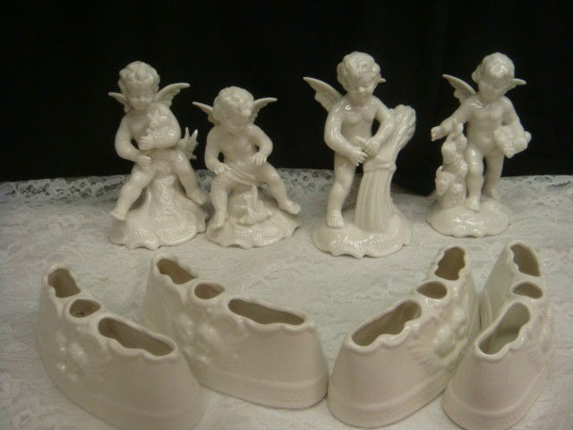 Eight Piece Cherubs and Flower Holders: Eight Piece Cherubs and Flower Holders: Four Cherubs in Different Poses with 4 Curved and Slotted Flower Holders. Cherubs are 5" to 6"T.Flower Holders are 2 1/4"T, 5 3/4"L. Mark is D Under Crown.