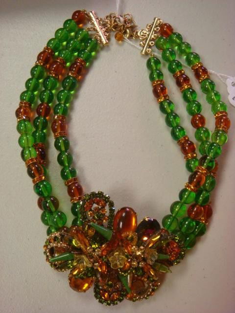 PHILIPPE FERRANDIS Green and Amber Stone Necklace: PHILIPPE FERRANDIS Green and Amber Stone Necklace: Three Rows of Green and Amber Beads with Amber Crystal Bands. Green and Amber Crystal Stone Centerpiece with Blown Glass Flowers and Accents. Filigre