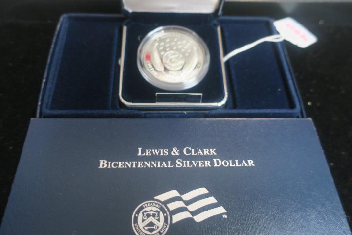 2004 LEWIS AND CLARK BICENTENNIAL COMMEMORATIVE COIN:: 2004 LEWIS AND CLARK BICENTENNIAL COMMEMORATIVE COIN: Proof .90% Silver Dollar Features Lewis and Clark on Obverse and Jefferson Peace Medal on Reverse. With Certificate of Authenticity in Original Pa