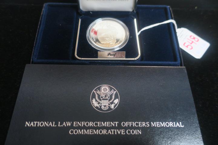 NATIONAL LAW ENFORCEMENT OFFICERS MEMORIAL PROOF COIN:: NATIONAL LAW ENFORCEMENT OFFICERS MEMORIAL PROOF COIN: 1997 Commemorative Proof One Ounce 90% Silver Dollar. With Certificate of Authenticity in Original Packaging and Velvet Display Box. Starts at $2