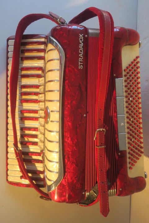 Italian STRADAVOX 1960's Accordion:: Italian STRADAVOX 1960's Accordion: Red with Pearl Finish. 120 Bass Buttons, 41 Keys, Master and 8 Switches Above Keyboard. Not Tested. Removable Back Pad. Alligator Look Case. (300-600)
