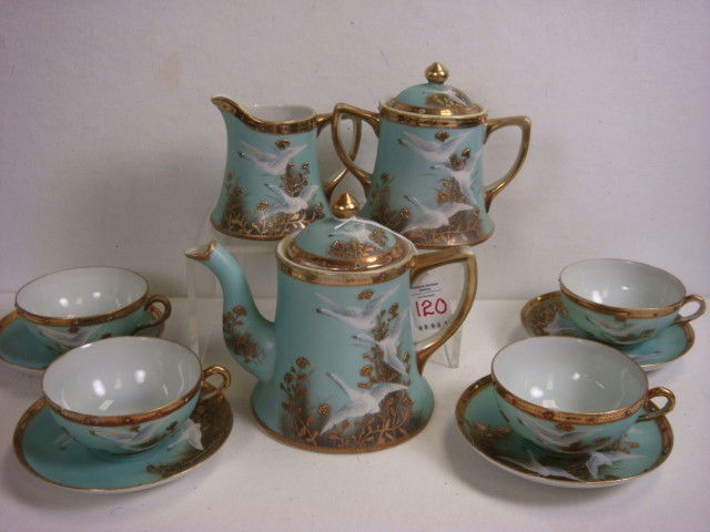 Handpainted NIPPON 11 Piece Snow Geese Tea Set: Handpainted NIPPON 11 Piece Snow Geese Tea Set: Set Includes 6 1/2"T Teapot, 5 1/4"T Lidded Sugar, 4"T Creamer, 4 Cups and 4 Saucers. One Saucer has Chip. Robins Egg Blue Ground with Flying Snow Geese