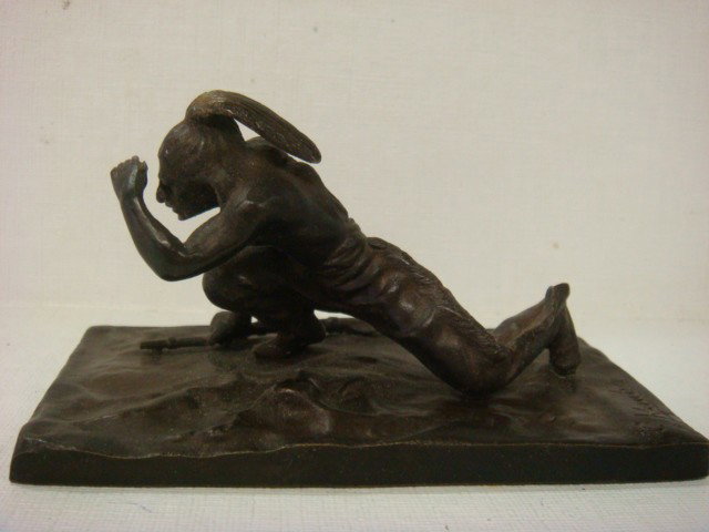 Bronze Plains Indian Signed C. Kauba:: Bronze Plains Indian Signed C. Kauba: Figure Shown in Crouched Lookout Position with Rifle on Ground. 4 1/2"W X 4 1/4"T. Carl Kauba (American, 1865-1922) (150-250)