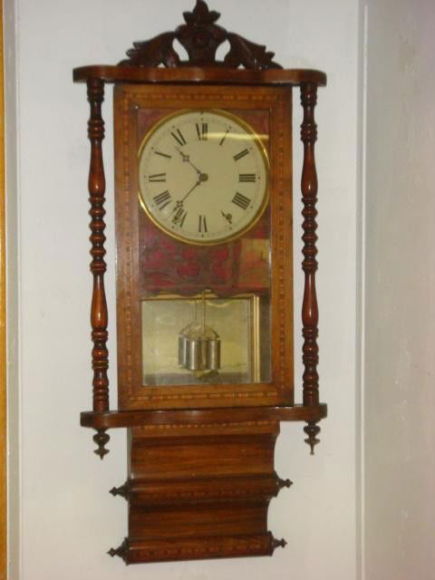 INLAID MIXED WOODS WALL CLOCK: Case with Multicolo: INLAID MIXED WOODS WALL CLOCK: Case with Multicolor Parquetry Inlay and Standaway Turned Side Columns. Carved Floral Inlay Around Glass Door & Scrolled Base . Nickel Cylindrical Pendulum. No ID Marks