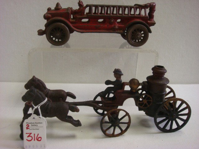 Cast Iron Toy Fire Engine and Fire Wagon:: Cast Iron Toy Fire Engine and Fire Wagon: Two Part Wagon with Rider and 2 Horses is 9 1/2"L and has Paint Flakes and Rust. 8" Fire Engine with Some Original Red Paint. (100-200)
