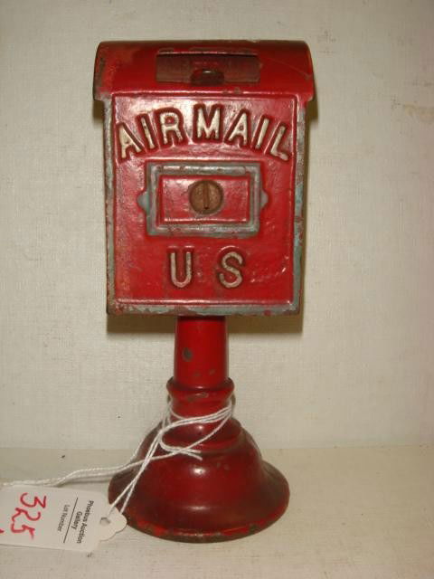 CAST IRON STILL BANK, by Dent Hardware Co.: CAST IRON STILL BANK, by Dent Hardware Co.: Fullerton, Pa. Red Paint with White Letters. Lift Mail Slot; Light Wear. 6.375"T, 2.62"W, 2.75"D. Literature "Penny Bank Book", Moore #848, P102. (300-500)