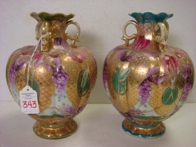 Two Handpainted NIPPON 9"T Lobed 3 Handled Vases:: Two Handpainted NIPPON 9"T Lobed 3 Handled Vases: Each Footed Vase has 3 Scroll Handles at Ruffled Neck. Handpainted Iris and Violets with Gold Beads on Gold. Green Rims on One Vase and Turquoise Rims