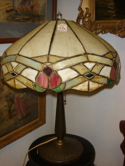 Bronze Lamp with Stained and Slag Glass Shade:: Bronze Lamp with Stained and Slag Glass Shade: Traditional Lead Came Technique. 12 Panels with Scalloped Edge with Floral. Polished Stem Set on Round Base with Incised Leaf Pattern Around Edge. Signat