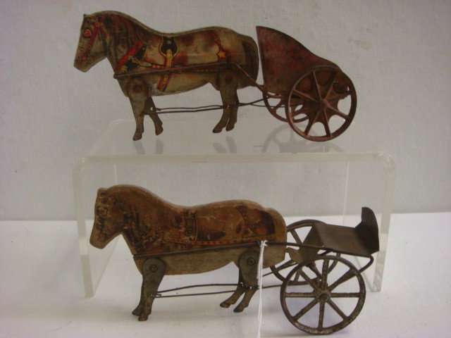 Two Toy GIBBS Wooden Horses Pulling Tin Carts:: Two Toy GIBBS Wooden Horses Pulling Tin Carts: Mixture of Wood and Tin, Made in Ohio. 1914 Catalogue Calls Them #6 Pony Chariot. Litho of Horse on Wooden Horse. Played with Condition. (200-300)