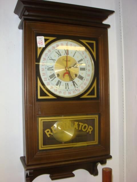 CENTURION 35 Day Regulator Wall Clock: CENTURION 35 Day Regulator Wall Clock: Mahogany Case, Key and Pendulum. 27"L. Beveled Pediment, 2 Key Slots, Indicator for Day of the Month. Single Glass Door. (120-300)