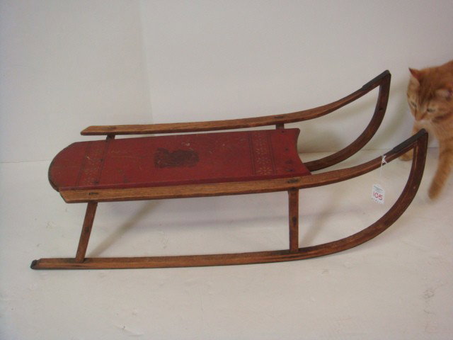 PARIS MFG CO #52 Wooden Child's Bowrunner Sled.: PARIS MFG CO #52 Wooden Child's Bowrunner Sled. Handmade in Maine, Late 19thC. 2 Runner, Oak with Red Center Board. Paris Supplied the Sleds for Admiral Peary. 12"T X 32"L X 12"W. (100-150)