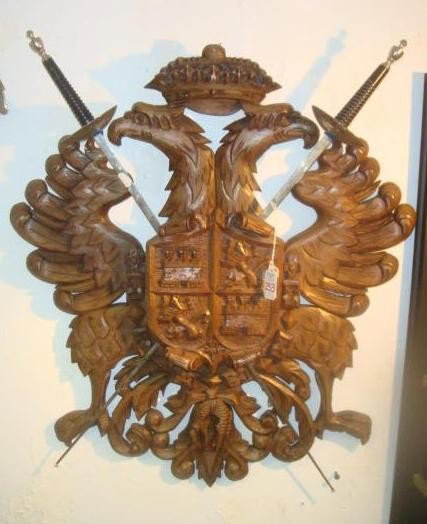 Wooden Crest of Castile & Leon with Fencing Swords: Wooden Crest of Castile & Leon with Fencing Swords: Kings Crown atop Double Eagles, with Crest Displaying Rampant Lions and Castles. Crossed Fencing Swords having 24" Blades. Symbol of the United Spai