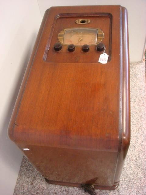 MOTOROLA American/Foreign Oak Case Shortwave Radio: MOTOROLA American/Foreign Oak Case Shortwave Radio: Waterfall Style Floor Model, 21"T X 25"L. Veneer Cracks. (100-200)