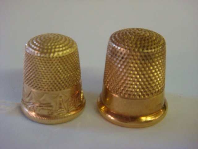 Two 14kt Gold Thimbles:: Two 14kt Gold Thimbles: Goldsmith-Stern 14kt Gold Thimble with Scenic Theme. Size 8. Gold Mark and Anchor Inside. 3.5 Grams. Victorian 14kt Rose Gold Ketchum & McDougall Thimble. 5.5 Grams. Size 9, Ma