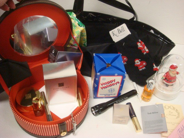 Black SAKS Tote with Makeup and Gifts: Black SAKS Tote with Makeup and Gifts: Red Skin Ornament, Guerlain Cologne, Shoe Key Ring. Estee Lauder Makeup Bag and Hatbox with Lotions and Creams. Hallmark Musical Ornament, Holiday Socks, Flash L