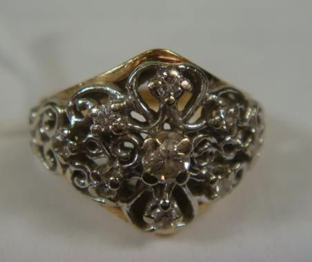 14K Diamond Filigree Ring: 14K Diamond Filigree Ring: Size 5 1/2, 5.1 Grams. White Gold Scroll Pierced Crown Set with 9 Round Diamonds, .2 CT Weight. On Wide Yellow Gold Band. (140-200)