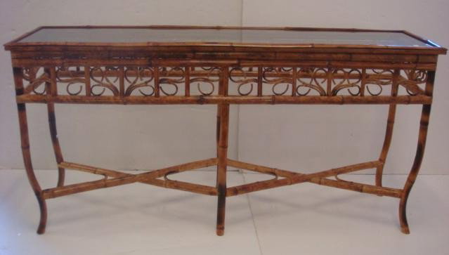 Bamboo Sofa Table with Glass Top:: Bamboo Sofa Table with Glass Top: Glass Insert Top on Well Defined Bamboo Frame. 8"D. Apron all four Sides with Open Curled Swirls. Two Tandem X Stretchers. 20th C. 29" X 60"W X 16"D. (200-300)