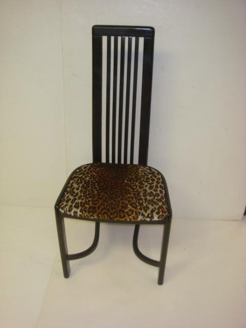 Six Retro Black Upholstered Dining Chairs:: Six Retro Black Upholstered Dining Chairs: Vertical Back Splat Continue to the Floor. The Side Chairs are High Gloss Black Paint with Leopard Seats (This Years Fashion Statement). 42" at Back, 17" at 