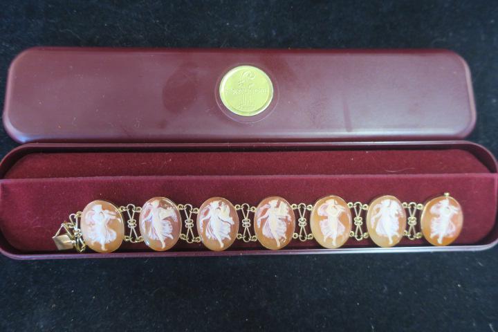 Fine Italian Hand Carved 18KT Cameo Link Bracelet:: Fine Italian Hand Carved 18KT Cameo Link Bracelet: Delicate Sculpted Carvings Depicting Seven Women Playing Flutes and Harps in Gossamer Gowns. Each Oval is Bezel Set in 18KT Gold Frame, Separated by