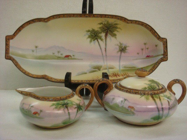 Hand Painted NIPPON Sugar, Creamer, Celery Dish:: Hand Painted NIPPON Sugar, Creamer, Celery Dish: All Hand Painted with Palm Trees, House, Lake and Mountains. Enameled Swirls and Beads on Rims. Lidded Sugar is 3 1/4"T, Creamer is 2 1/4"T and Celery 