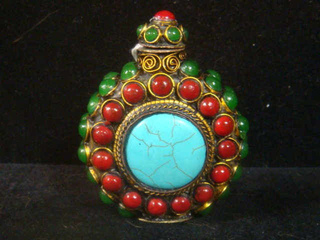 Jeweled Brass Snuff Bottle:: Signed Jeweled Brass Snuff Bottle: Red, Green and Turquoise Cabachon Stones with Metal Roping. Spoon in Cap. 3"T X 2 2/3"W. (100-200)