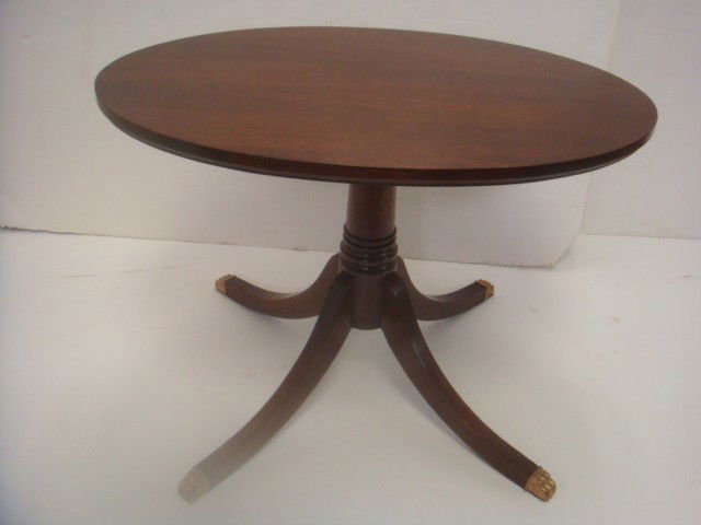 Petite Oval Mahogany Table with 4 Way Base: Petite Oval Mahogany Table with 4 Way Base: Duncan Phyfe Styling on 16 1/2"T Table with Splay Legs and brass capped Animal Feet. 24"W. (100-150)