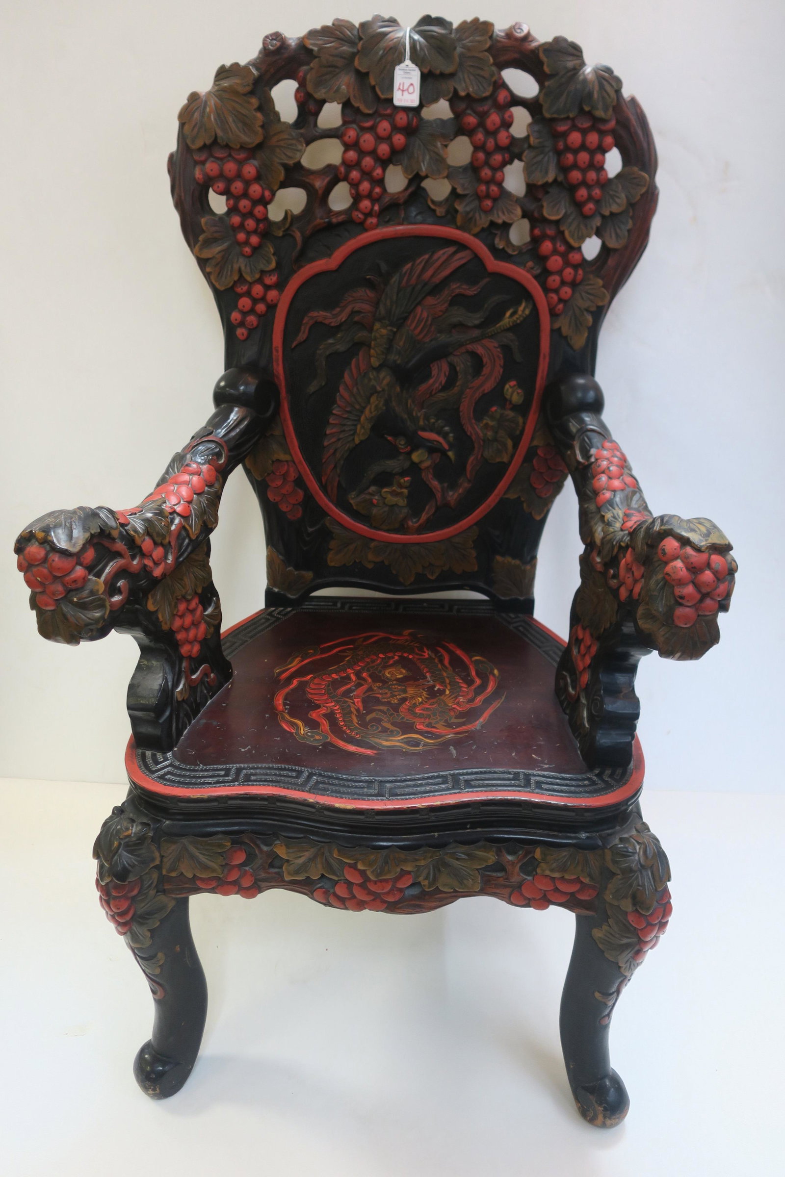 Estate ADM A. BURKE Carved Chinese Throne Chair:: Heavily Carved Chinese Polychrome Throne Chair: Phoenix & Dragon Pattern, Pierced Crest with Grapes and Phoenix in Shield, Dragon on Seat. Carved Grapes & Leaves Down Arms, Legs and Seat Rails. Carved