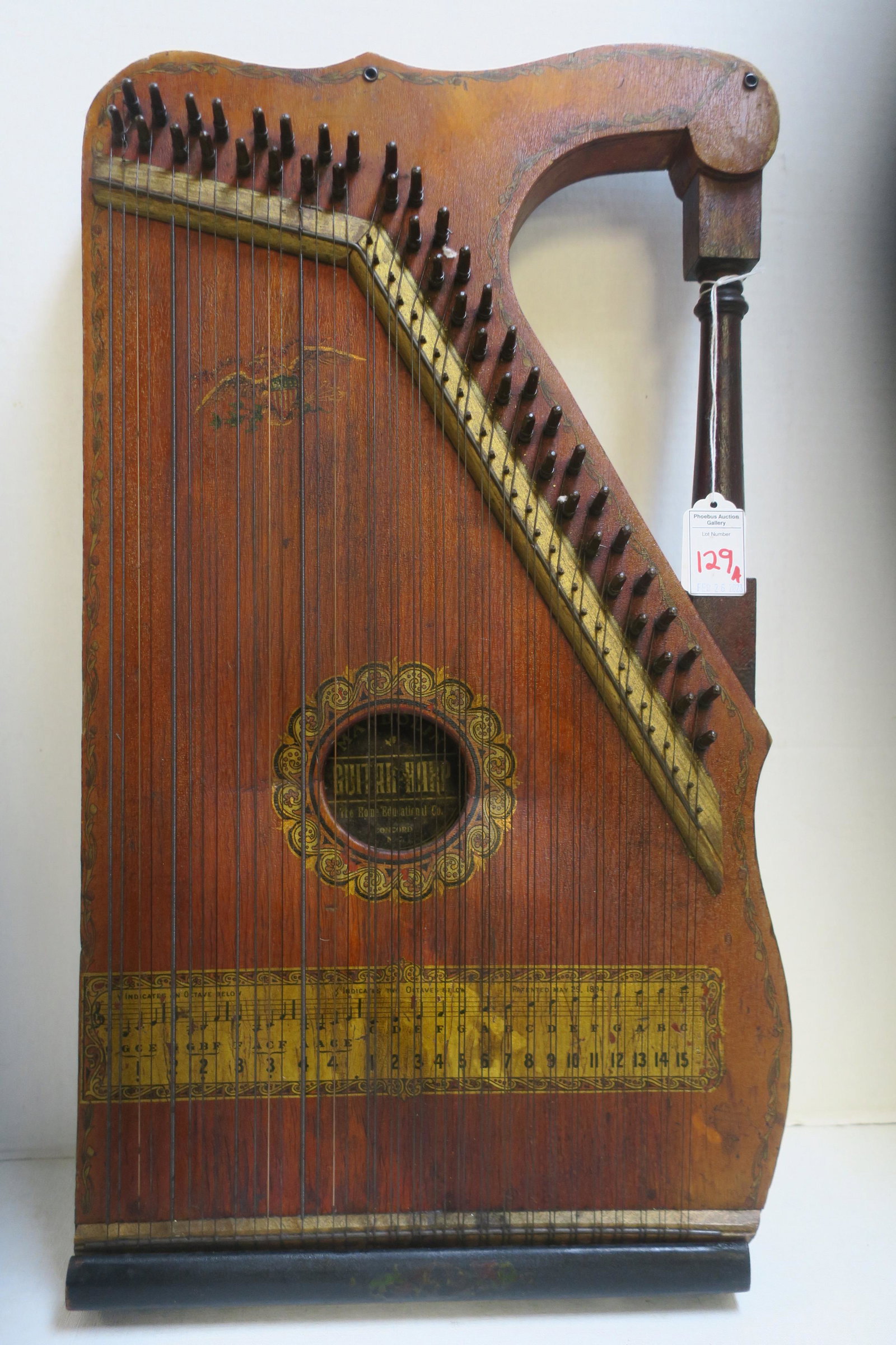 Antique-Mandolin Guitar Harp by Home Educational Co.: Antique-Mandolin Guitar Harp by Home Educational Co. Good Condition for 1894 Instrument. All Strings Attached, Musical Notes at Bottom. Mahogany Carved Wood Handle, Dark Oak Front. Concord N. Carolina