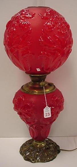 Red Victorian Gone With The Wind Lamp: Red Victorian Gone With The Wind Lamp: Has Blown Out Iris Pattern on 12" Spherical Globe and Base Over Pierced Brass Foot. 28"T Overall with Clear Glass Chimney. Almost Identical to a Bardley and Hubb