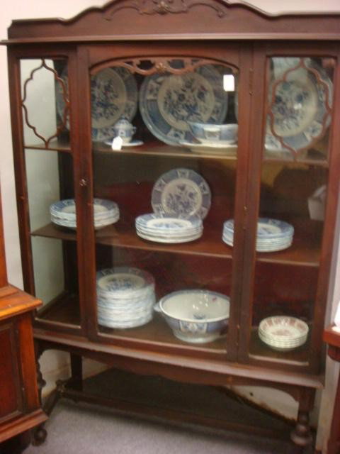 Depression Era Mahogany and Glass China Cabinet:: Depression Era Mahogany and Glass China Cabinet: Three Interior Shelves with Single Glass Front Door and Side Panels. Sculpted Crest with Applied Shell Design. Turned Legs Supported by H Stretcher. 40