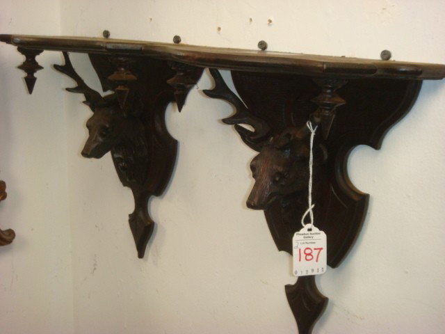 Pair of Handcarved Black Forest Stag Head Shelves:: Pair of Handcarved Black Forest Stag Head Shelves: Carved Full Head and Back Splat. Turned Drop Finials. 11"T. German Shelf Bracket is Supported by Dear Head. Scribe Carved, Original Finish. (100-200)