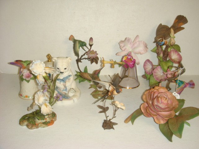 Eleven Porcelain Bird, Flower, Bell, Bear Figurine: Eleven Porcelain Bird, Flower, Bell, Bear Figurines: Three Hummingbirds and Royal Worcester Swallow on Metal Stems; Glass Bell with Orchid; Lenox Bell with Hummingbird, Iris and Musical Bell; Bird wit