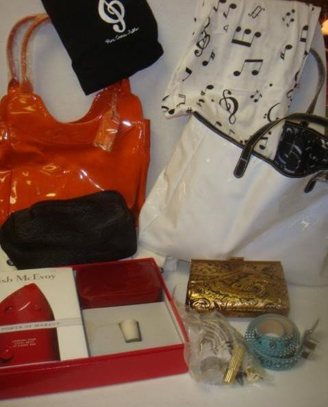 Black and White SAKS Tote with Gifts and Makeup:: Black and White SAKS Tote with Gifts and Makeup: Neiman Marcus Tote with Makeup and Orange Purse, 2 Estee Lauder Makeup Cases, McEvoy Makeup Gift Set, Hatley PJ's, Santini and Lilly Belts. (60-100)