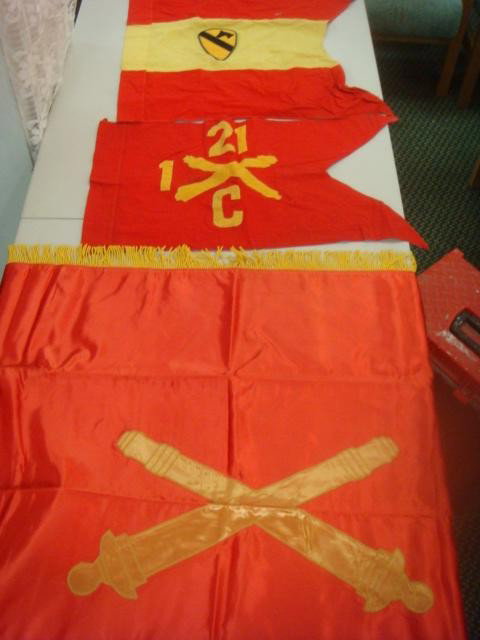 Three Artillery Flags and Guidons:: Three Artillery Flags and Guidons: Headquarters Battery, 1st Cavalry Division Guidion with Patch, C Battery 1/21 Field Artillery Guidon, and Division Artillery Colors with Crossed Cannons & Yellow Fri